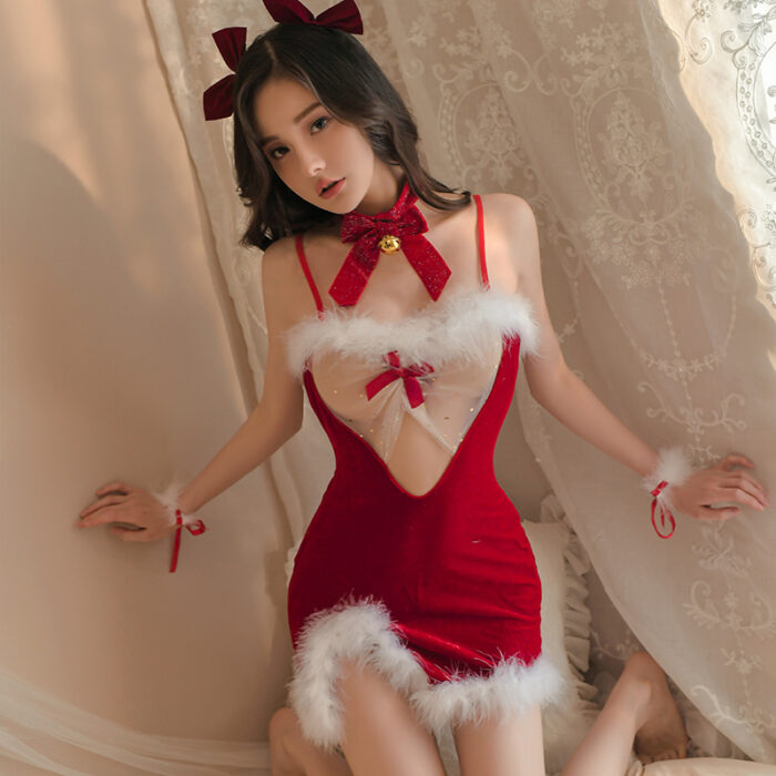 A person wearing a "Sexy lingerie, women's uniforms, temptation suits, bed passion, sexy perspective mesh temptation hollow Christmas dress" is kneeling on the floor in front of a window with sheer lace curtains. They have accessorized with a matching red bow headband and collar featuring a gold bell, as well as red wristbands adorned with small bows.