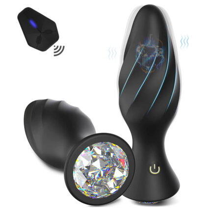 A black, spiral-shaped vibrating plug with a sparkling crystal base and a power symbol. It features blue LED lines along the length and comes with a remote control.

Wireless Remote Control Diamond Anal Plug, Prostate Massager:
This sleek, black spiral-shaped anal plug is designed for both men and women. Adorned with a sparkling crystal base that boasts the power symbol, its elegant appearance is highlighted by blue LED lines running along its length. The device is equipped with a wireless remote control for seamless operation and offers powerful vibrating functions to enhance your experience.