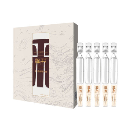 The image shows a boxed Female Pleasure Essence Pack containing glass ampoules. The box features a minimalist beige design with a swirl pattern and a central transparent panel displaying brown text. Next to the box, there are five transparent glass ampoules, each filled with a light-colored liquid.