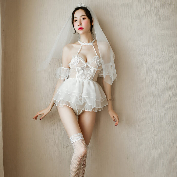 A woman wearing the Sexy Lingerie, Feminine Temptation Transparent White Wedding Dress Bridal Suit stands against a plain background. The set includes a short skirt with garter straps and white lace thigh-high stockings. She completes the look with a white veil on her head, styled hair, and subtle makeup.