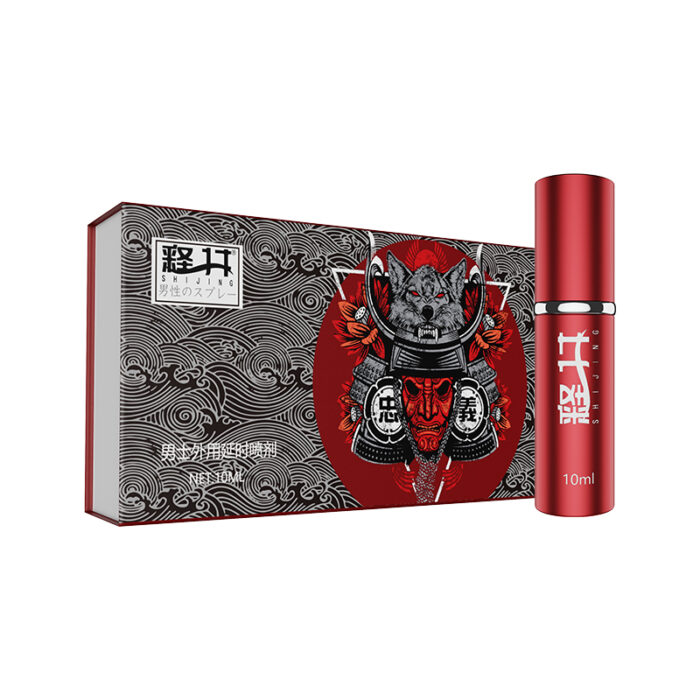 A 10ml bottle of the "For Men - External Use Spray - Wash Free - Lickable - Long-Lasting - Non Allergic - Delayed Spray (Red Luxury)" with Japanese text, placed beside a matching decorative box. The box features intricate black and white designs, complemented by a bold red circle framing an illustration of a samurai helmet adorned with red flowers.