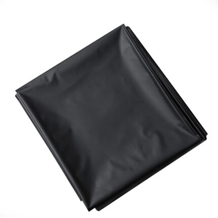 A neatly arranged SM erotic bed sheet, crafted from smooth and slightly reflective black plastic, lies folded against a white background.