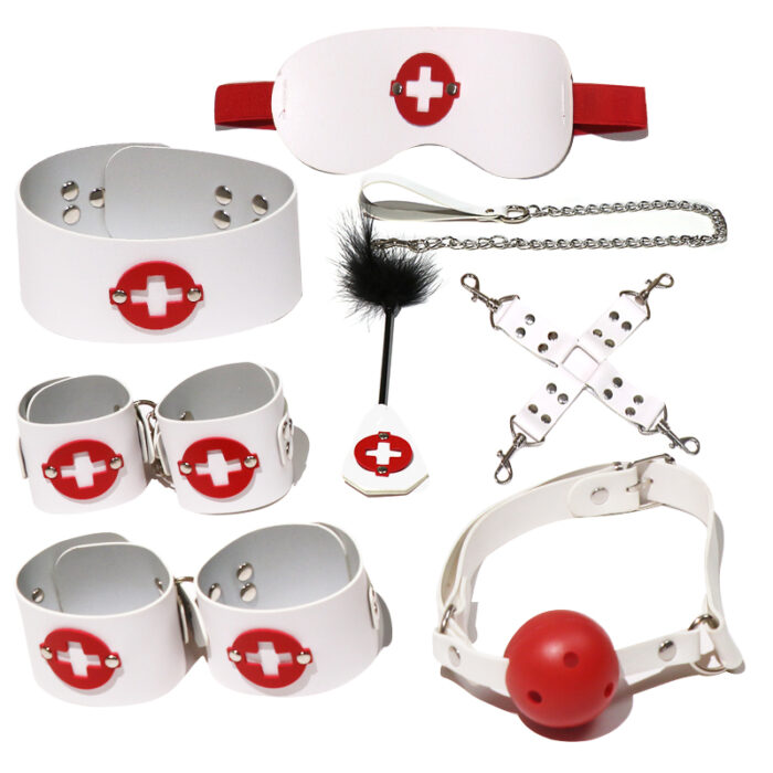 A white and red nurse-themed BDSM kit that includes an eye mask, wrist cuffs, ankle cuffs, collar, leash, ball gag, and feather tickler. The set is made from high-quality materials, designed to add a playful and exciting element to your role-playing scenarios.